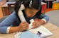 girl reading book out loud for herself